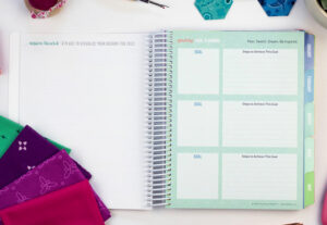 The Quilter's Planner goal setting page with quilting accessories